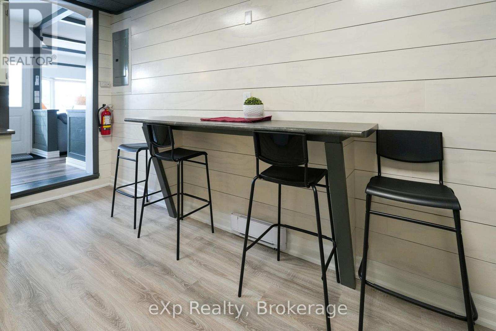 A dining area with a table and four chairs.