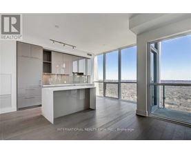 A modern kitchen with a large island and a view of the outdoors.