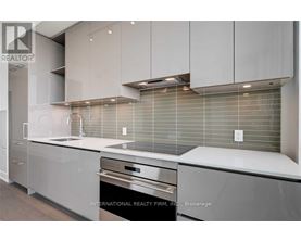A modern kitchen with stainless steel appliances and white cabinets.