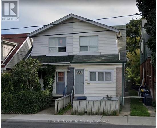 A two-story house with a blue door and a small porch.