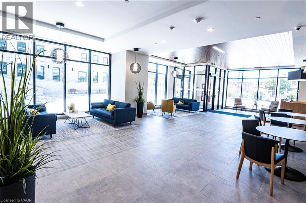 A spacious waiting area with blue sofas and wooden chairs.