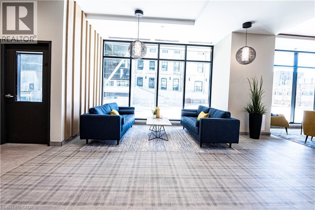 A realtor's office with two blue couches and a large window.
