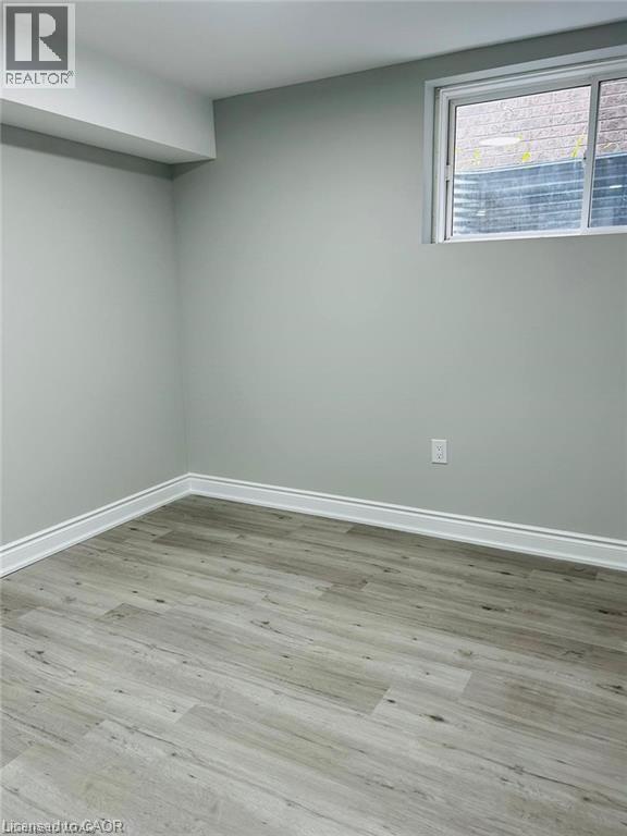 A room with a window and wooden flooring.