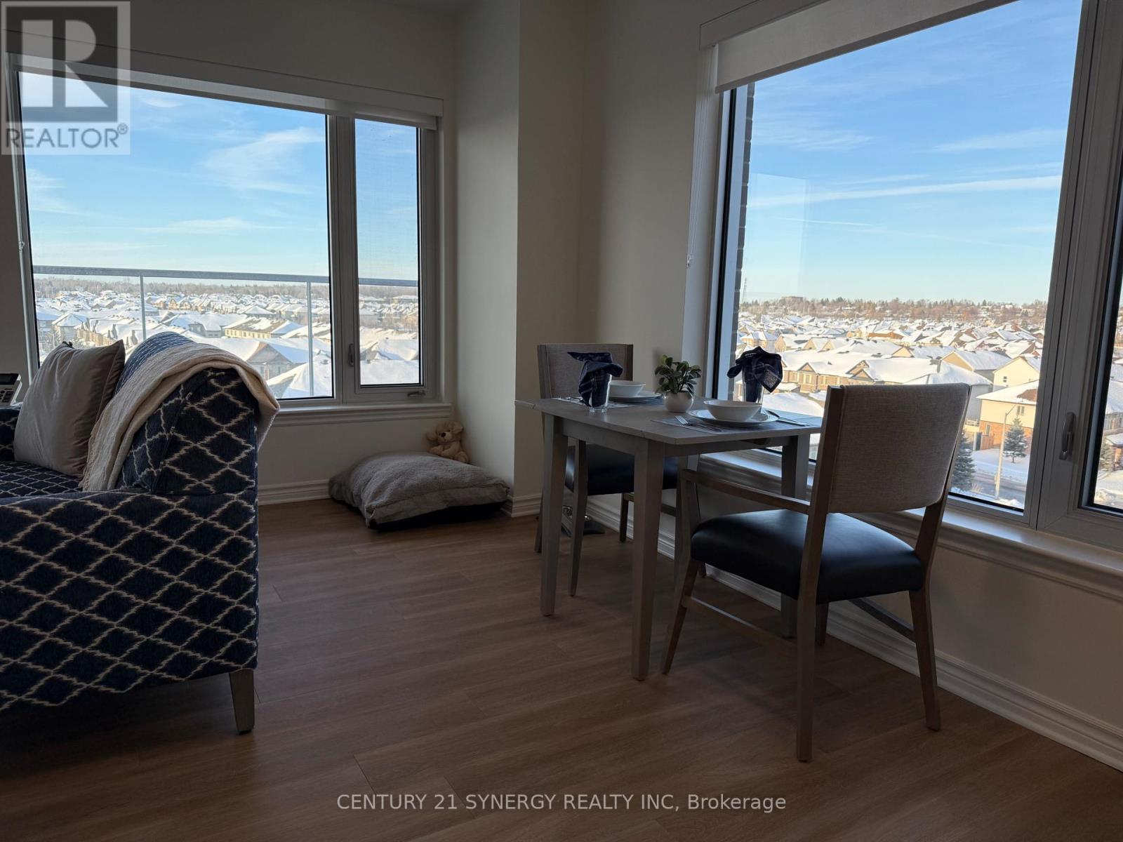 A bedroom with a large bed and a table with chairs.