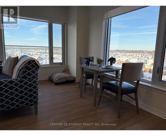A bedroom with a large bed and a table with chairs.