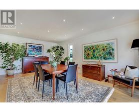 A dining room with a table set for four.