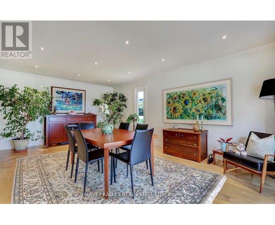 A dining room with a table set for four.