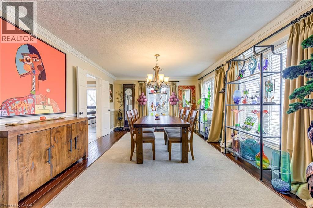 A dining room with a wooden table and chairs.