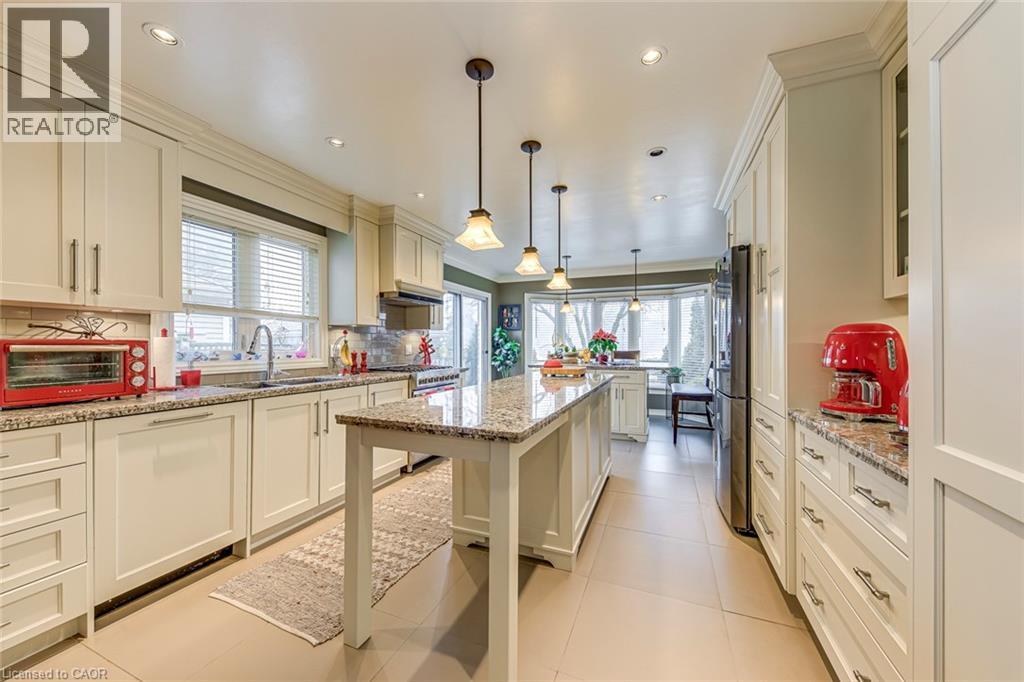 A kitchen with white cabinets and a large island.