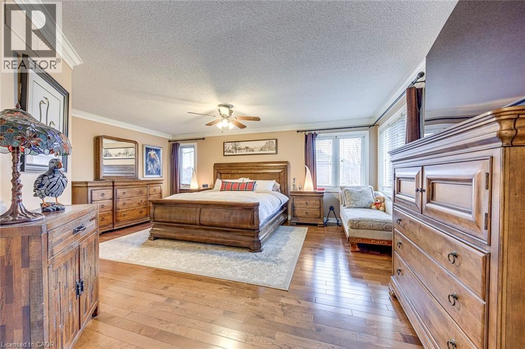 A bedroom with a large bed and wooden furniture.
