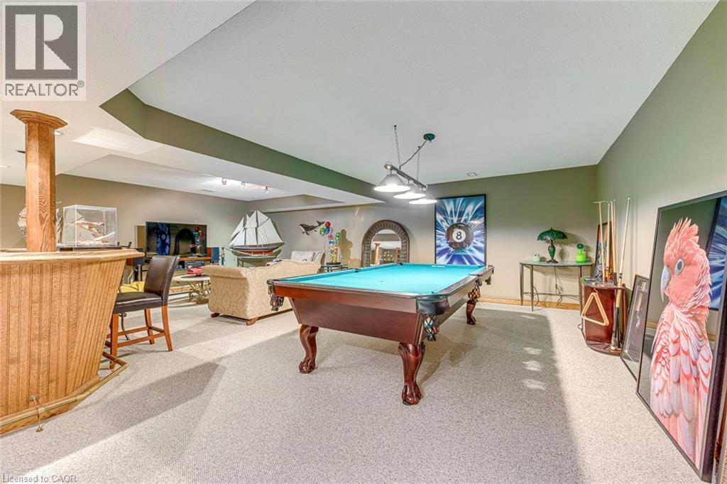 A room with a pool table and a billiard table.