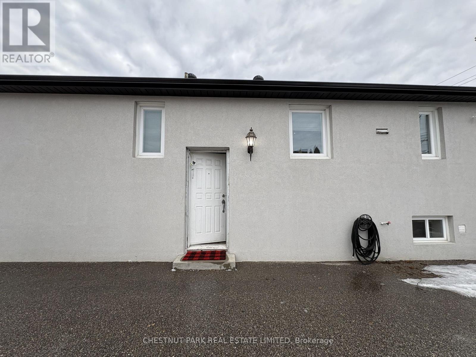 A house with a white door and windows is for sale.