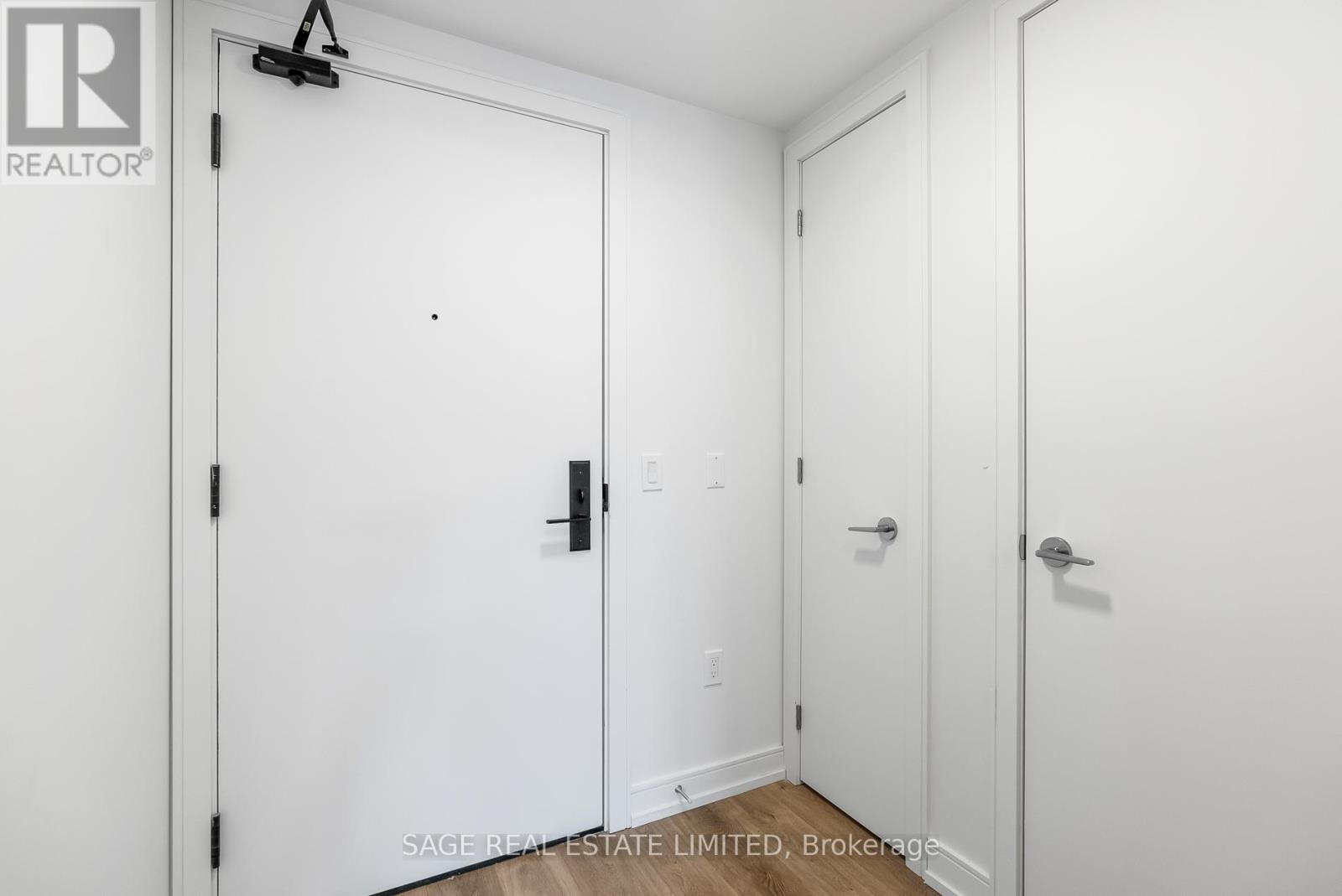 A white door with a black handle and a black lock.