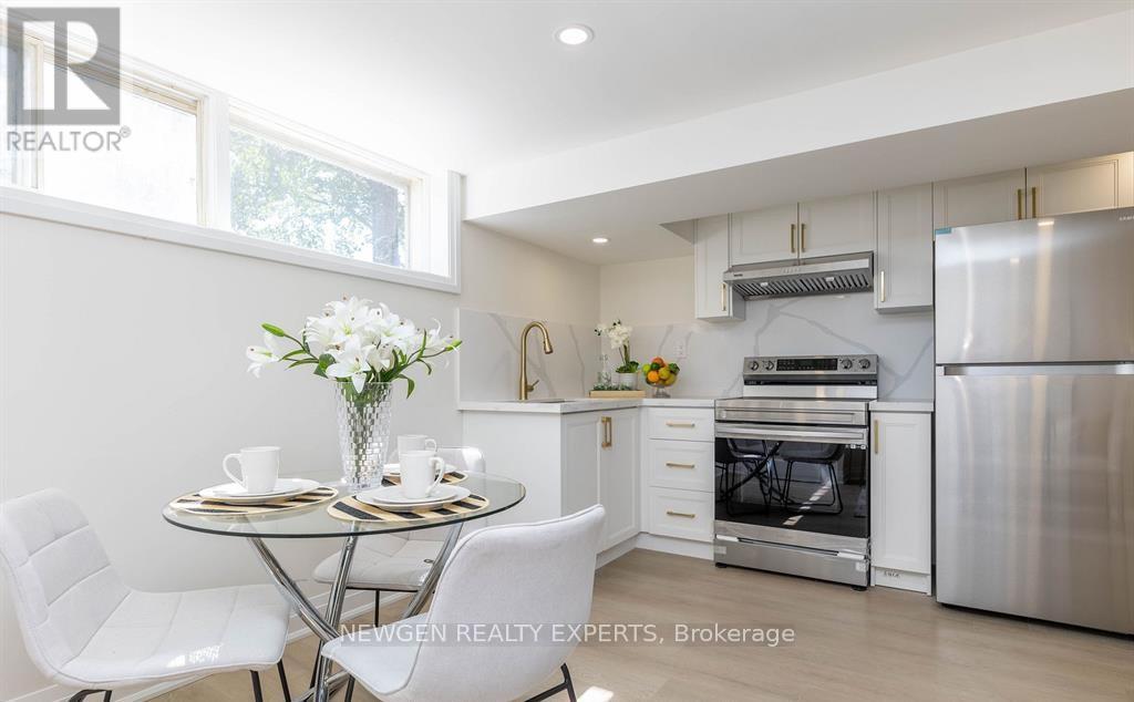 A modern kitchen with a dining table set for two.