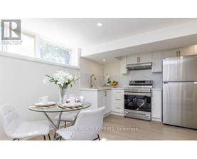 A modern kitchen with a dining table set for two.
