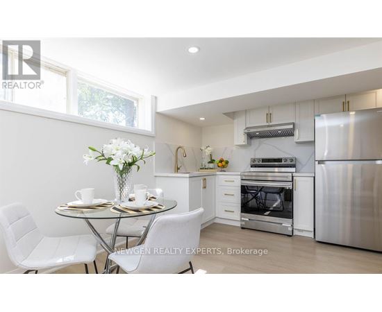 A modern kitchen with a dining table set for two.