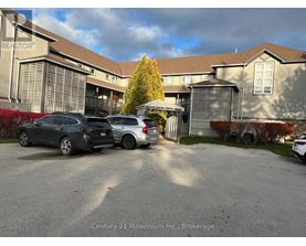 A parking lot with cars and a building in the background.