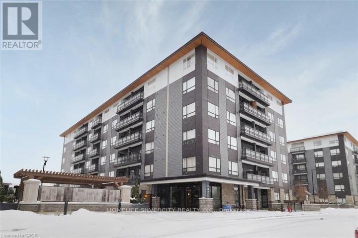 A large, modern apartment building with a flat roof and balconies on the upper floors.