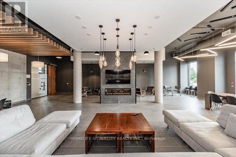 A modern living room with a wooden coffee table and white sofas.