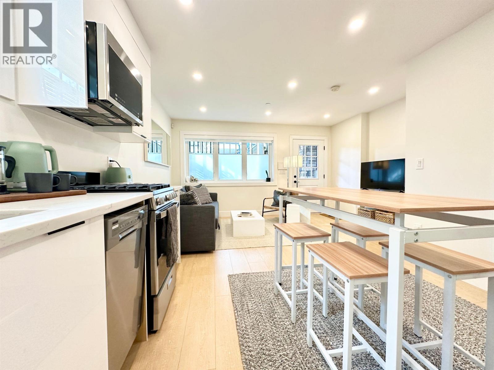 A kitchen with a bar area and a window.