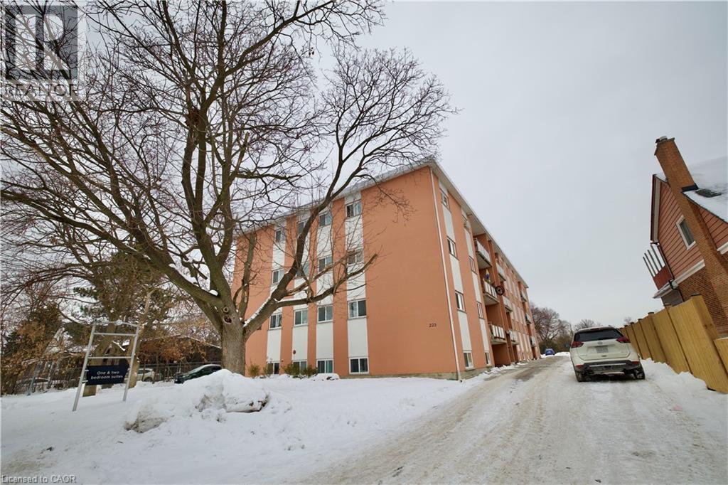 A car is parked on a snowy street in front of a building.