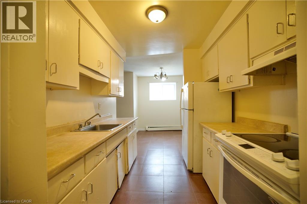A kitchen with white cabinets and appliances.