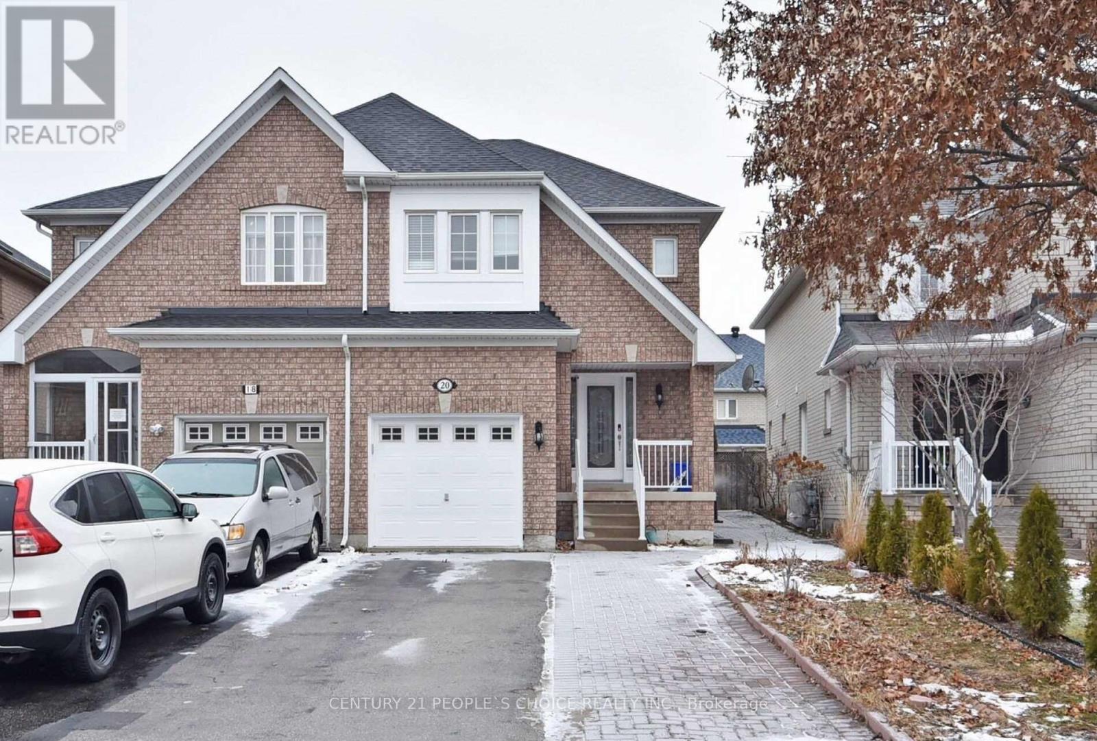 A house with a white car parked in front of it.