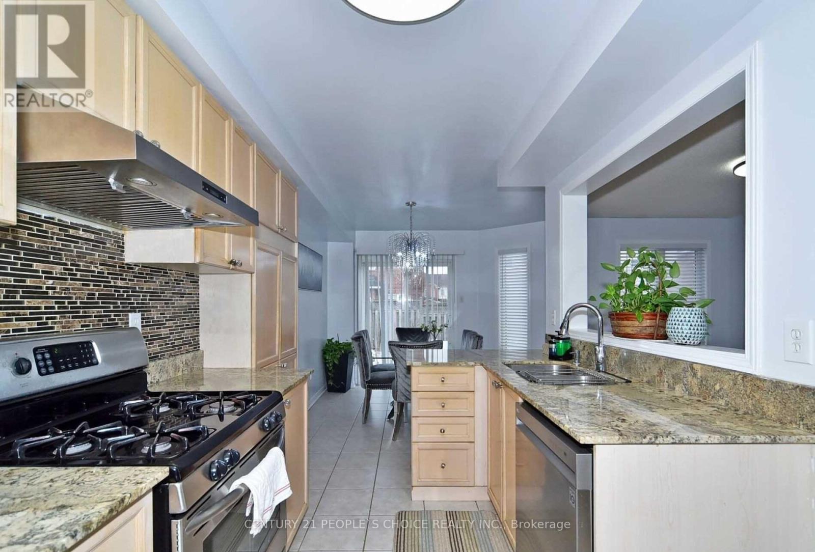 A kitchen with granite countertops and a stove top oven.