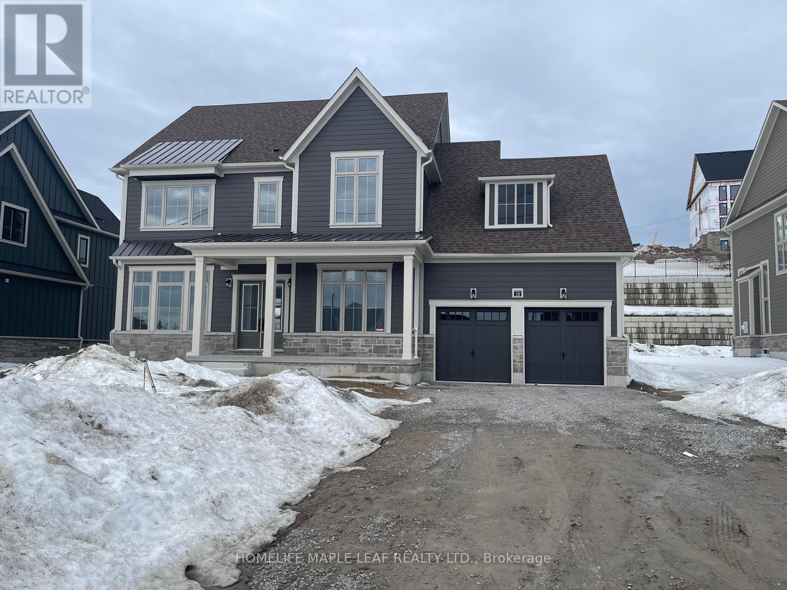 A house with a garage is under construction in a snowy area.