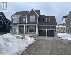 A house with a garage is under construction in a snowy area.
