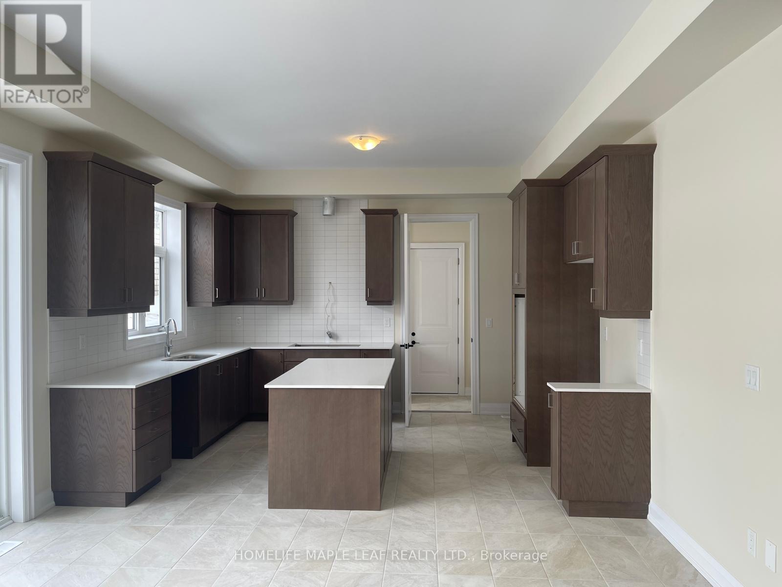 A kitchen with brown cabinets and a white countertop.