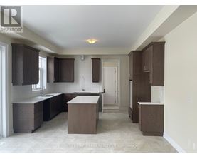 A kitchen with brown cabinets and a white countertop.