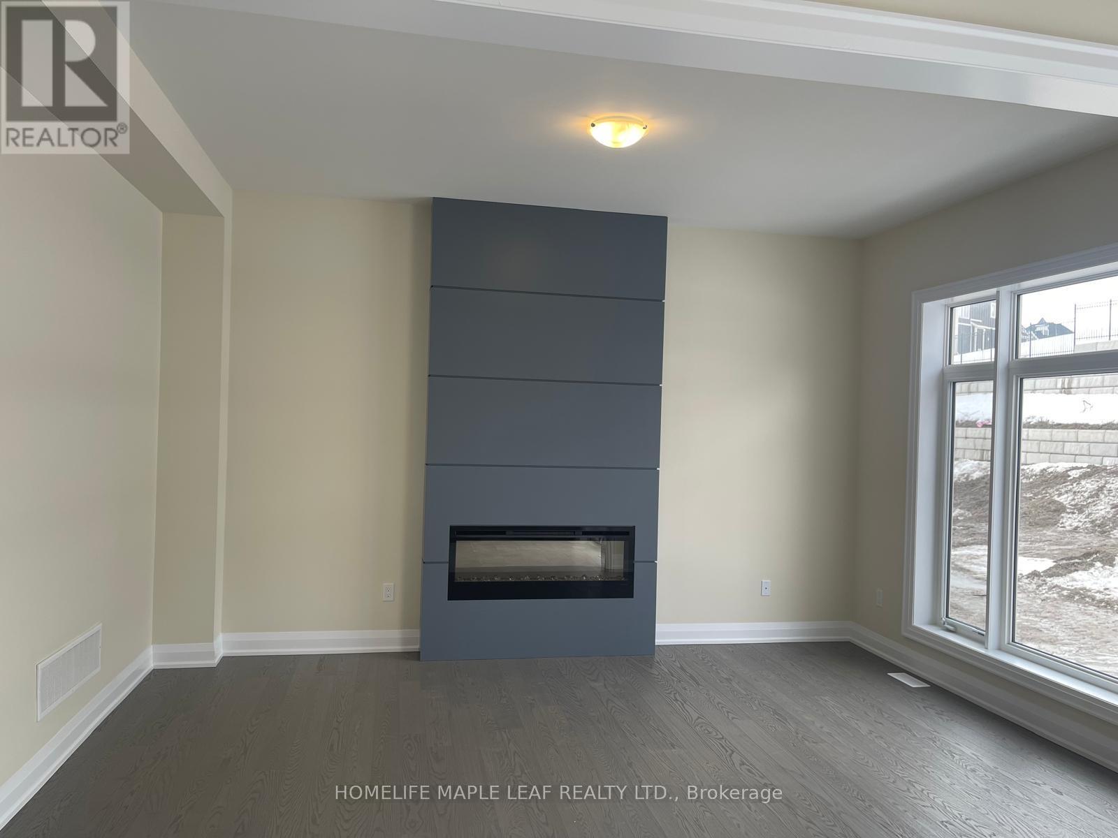 A room with a fireplace and a window showing a snowy landscape.