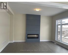 A room with a fireplace and a window showing a snowy landscape.