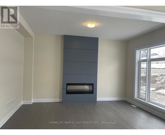 A room with a fireplace and a window showing a snowy landscape.