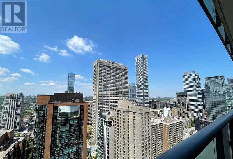 A cityscape with tall buildings under a clear blue sky.