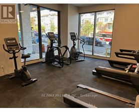 A gym with treadmills, elliptical machines, and stationary bikes.