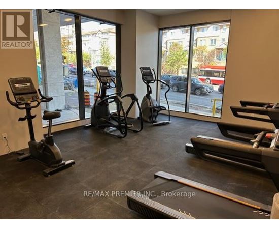 A gym with treadmills, elliptical machines, and stationary bikes.