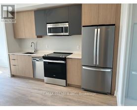 A kitchen with a stainless steel refrigerator and dishwasher.