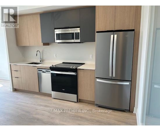 A kitchen with a stainless steel refrigerator and dishwasher.