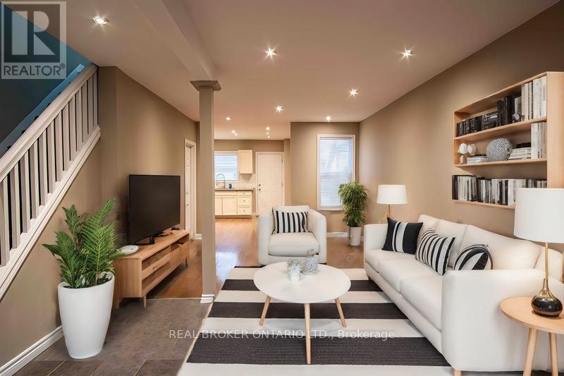 A well-lit living room with a staircase on the left side.