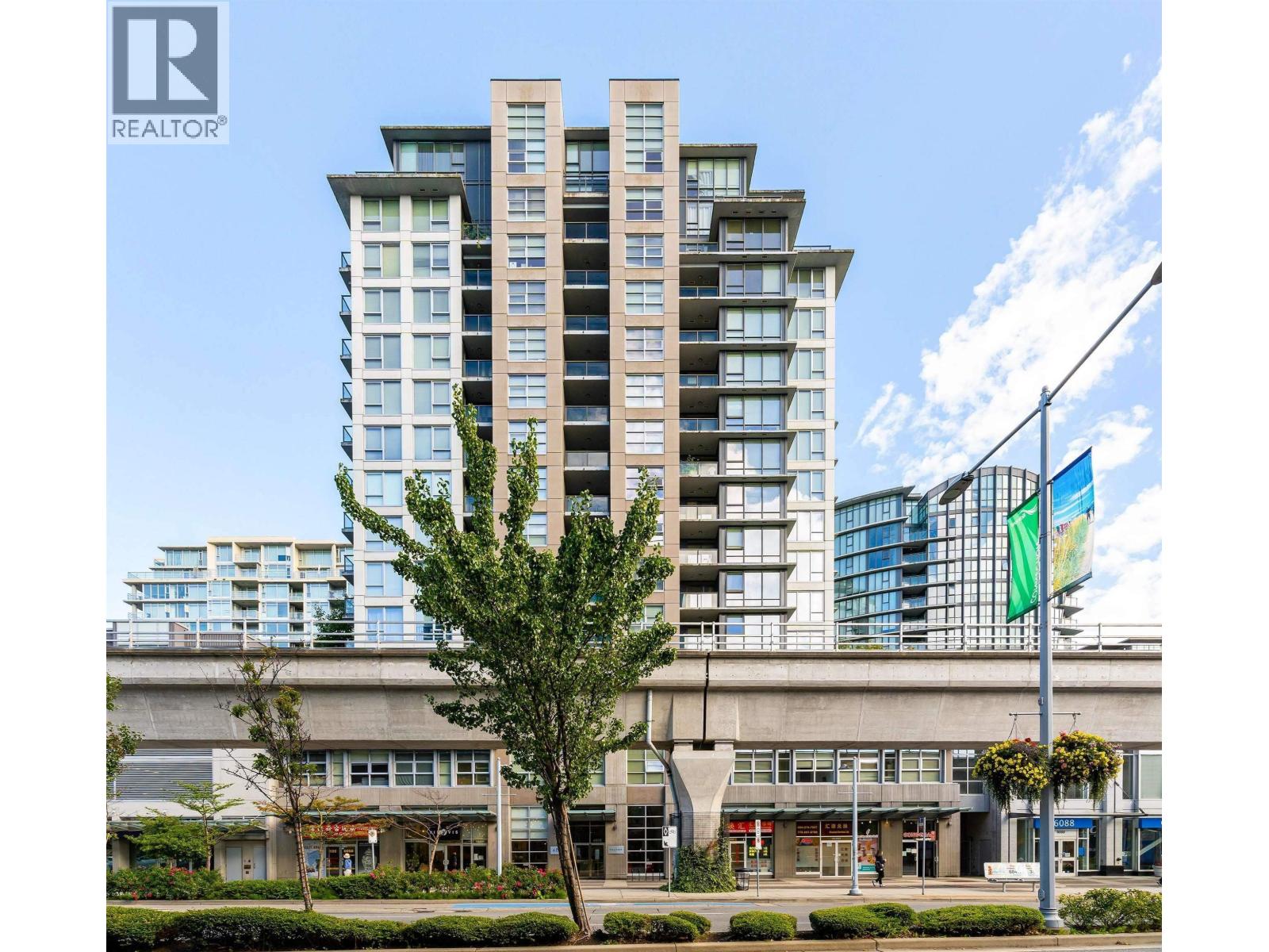 A tall building with a green tree in front of it.