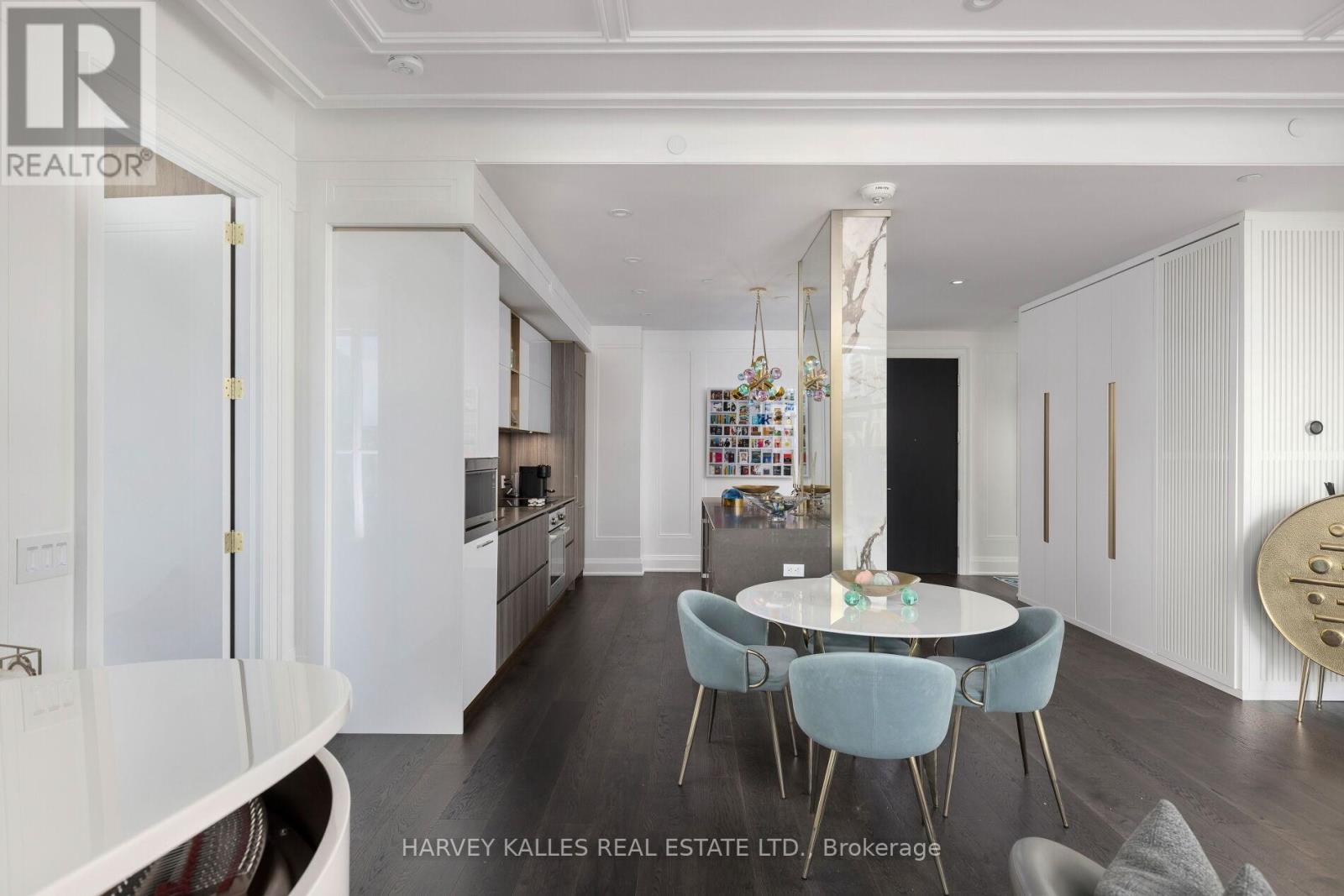 A modern kitchen with a dining table and chairs.