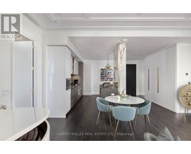 A modern kitchen with a dining table and chairs.