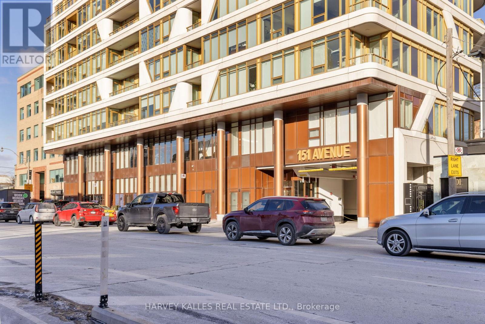 A building with the number 151 on it is shown with cars parked in front.