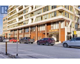 A building with the number 151 on it is shown with cars parked in front.