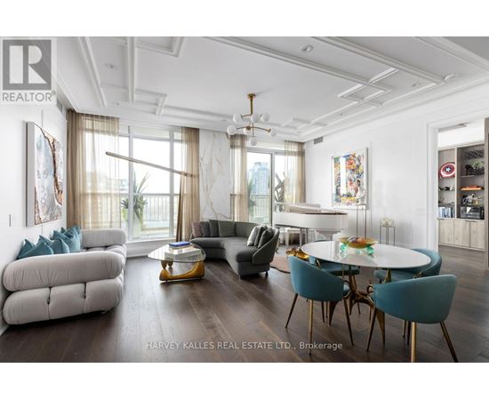 A well-lit, spacious living room with a dining table and chairs.