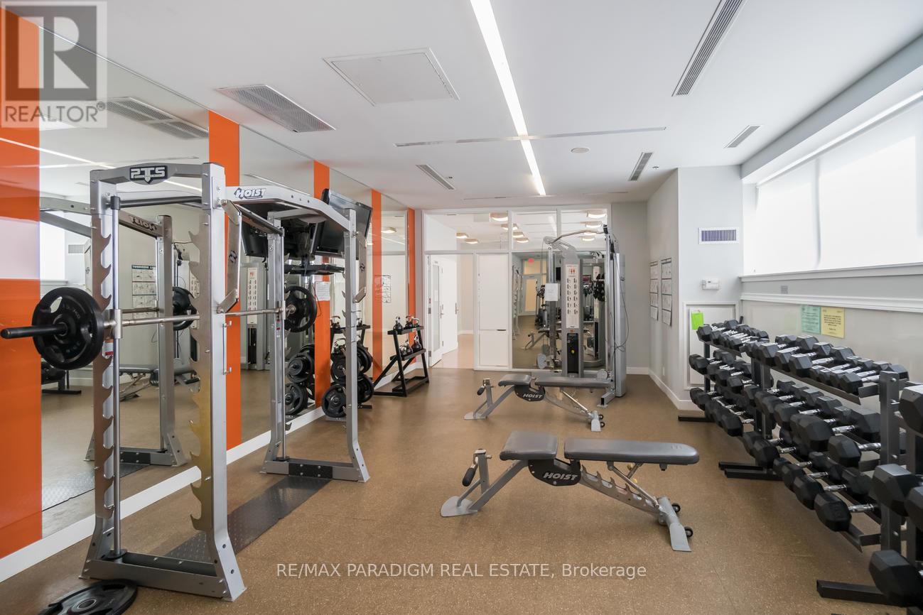 A gym with orange walls and a variety of equipment.