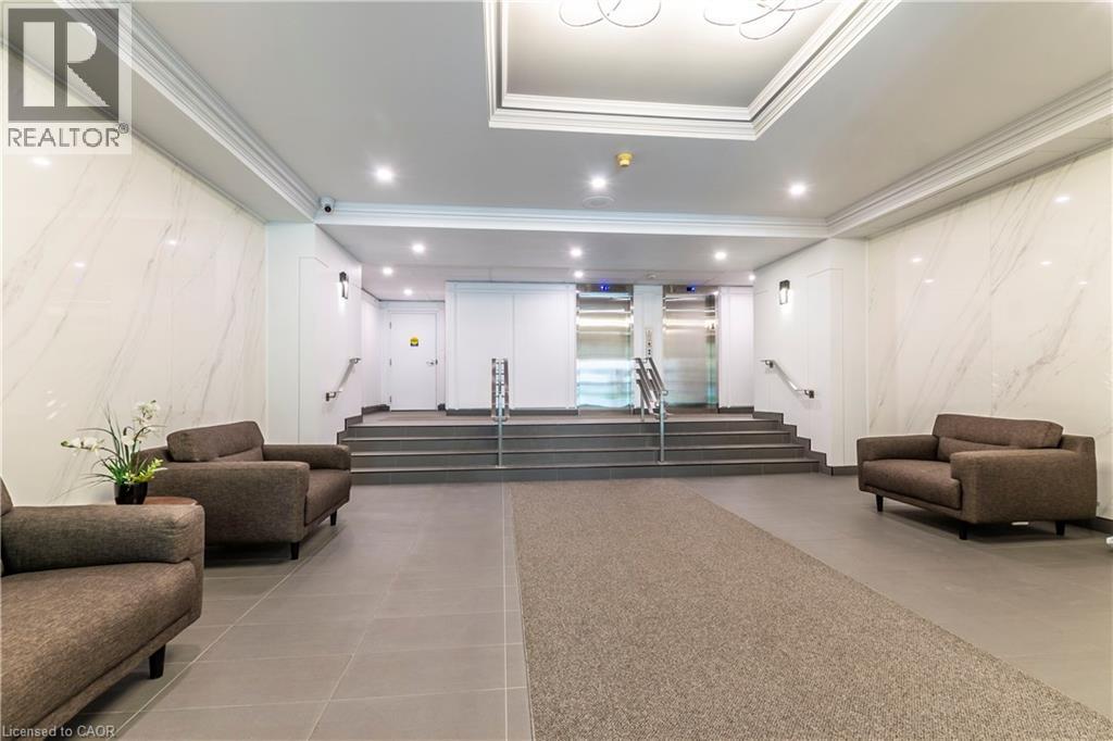 A spacious living room with a staircase leading to the upper floor.