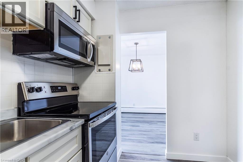 A kitchen with a stove top oven, microwave, and dishwasher.